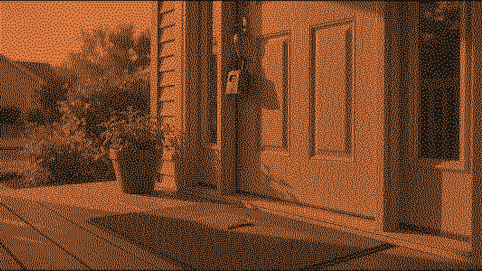 A steel lockbox hanging from the handle of a painted front door, with a watering can and two folded chairs on the porch beside it, in low gold light an hour before sunset.