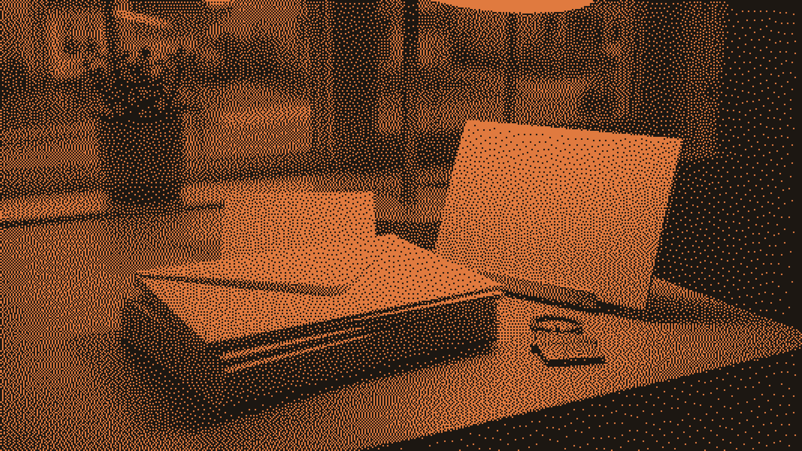 A stack of blank cream note cards and envelopes on a home office desk beside a brass house-shaped keyring, one card propped open under a warm desk lamp with a quiet street out the window.
