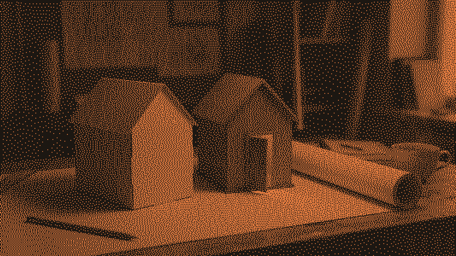 Two small model houses on an architect's drafting table, a plain folded-cardboard kit house beside a hand-built wooden one whose open door spills warm orange light onto a blank roll of paper.